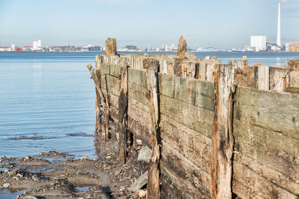 Broken pier on the sea under the clear sky bulkhead erosion and soil loss behind broken boards
