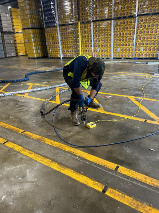 Screenshot 2026-07-09 110757 PolyTex Concrete technician lifting a commercial concrete slab using polyurethane foam injection