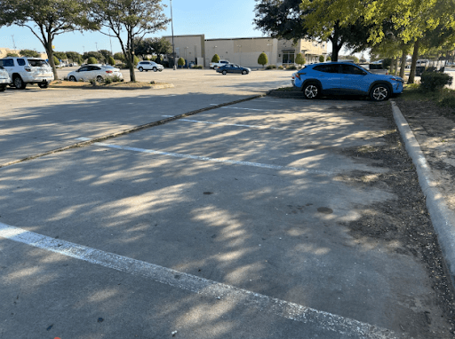 commercial parking lot with settling uneven concrete that needs polytex injection