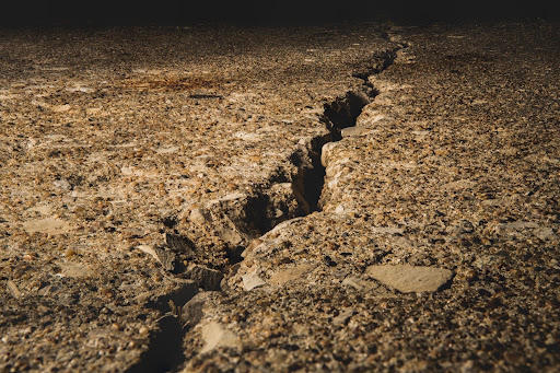 large crack in the ground uneven soil